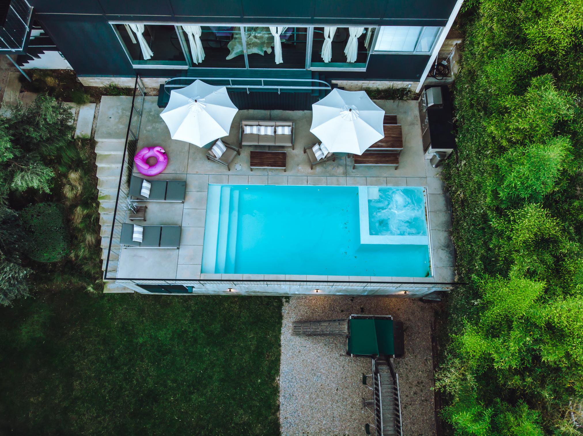 An aerial view of a pool and patio area.