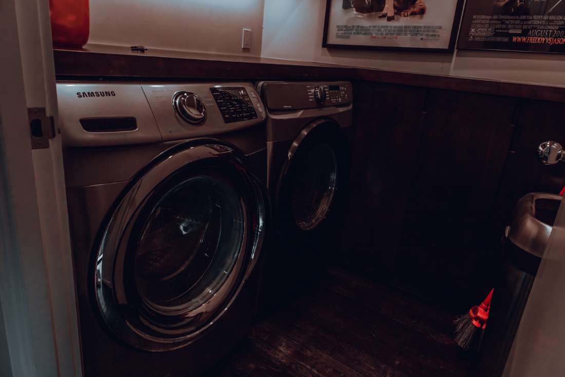 A couple of washing machines in a room.