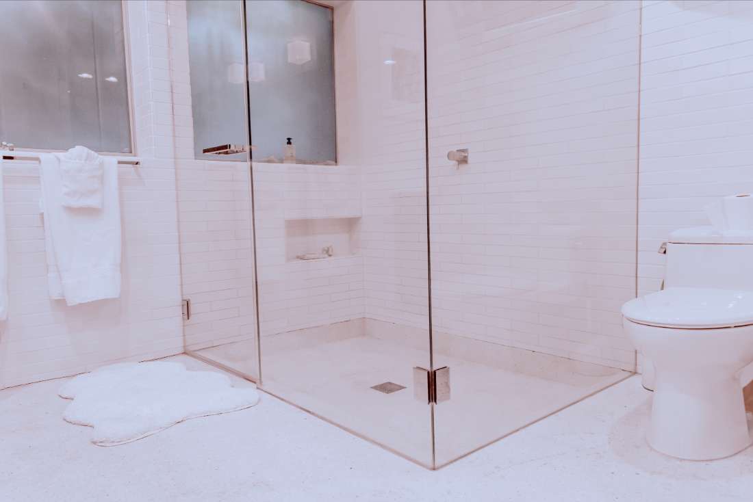 A bathroom with a large walk in shower.