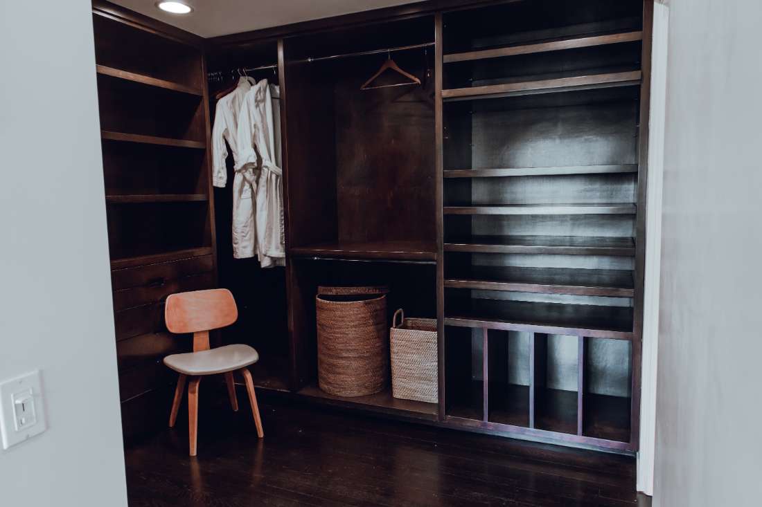 A room with a chair and shelves in it