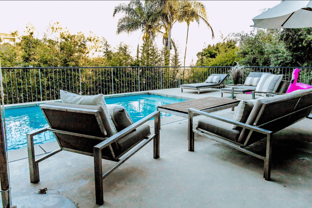 A pool with chairs and tables in it