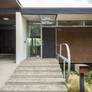 A concrete staircase leading to the front door of a house.