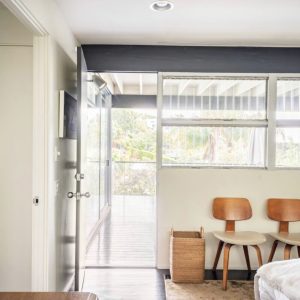 A room with two chairs and a bed