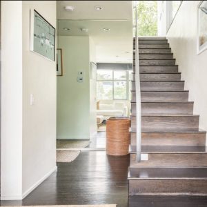 A staircase with wooden steps and white walls.