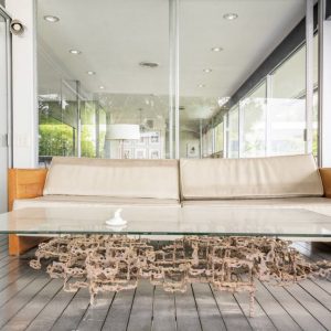 A couch with a glass table on top of it