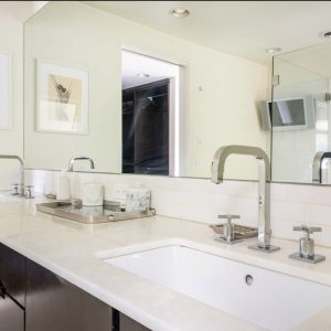 A bathroom with a sink and mirror in it