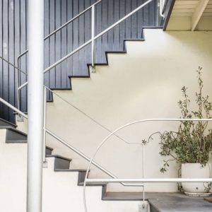 A staircase with metal handrails and white steps.