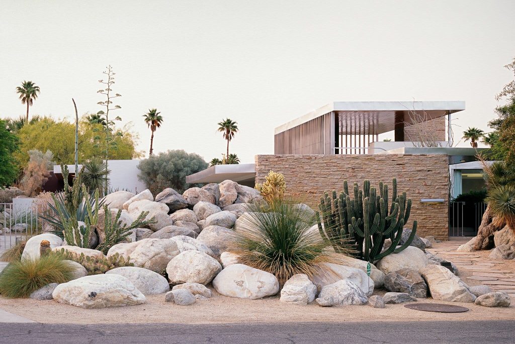 A house with a lot of rocks and plants