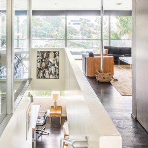 A room with lots of windows and furniture.