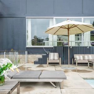 A patio with an umbrella and some chairs