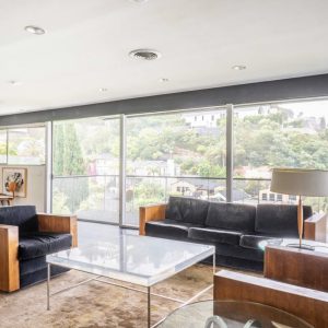 A living room with couches and tables in it